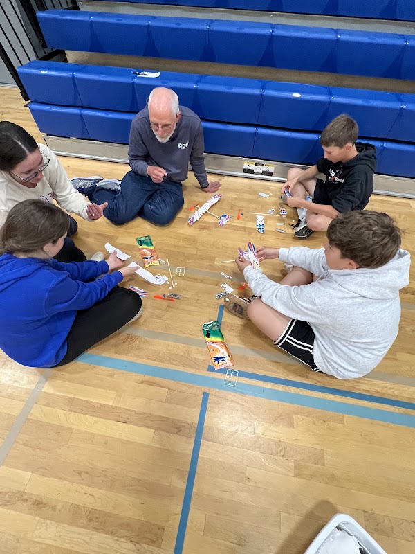 Students examining a PASS glider
